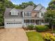 Charming two-story home boasts a well-manicured lawn, two car garage and inviting front porch at 200 Frenchmans Bluff Dr, Cary, NC 27513