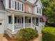 Inviting front porch with white railings and comfortable seating, perfect for relaxing at 200 Frenchmans Bluff Dr, Cary, NC 27513