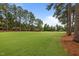Wide shot of the community golf course with mature trees lining the manicured fairways at 200 Frenchmans Bluff Dr, Cary, NC 27513