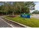 Well-maintained neighborhood sign with a lush green lawn, flowers, and plenty of trees in the surrounding area at 200 Frenchmans Bluff Dr, Cary, NC 27513