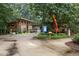 Town park featuring wooden buildings, a map kiosk, and a paved entrance, perfect for outdoor recreation and relaxation at 200 Frenchmans Bluff Dr, Cary, NC 27513
