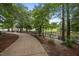 Picturesque view of a paved pathway, wooden fence and serene lake within the community at 200 Frenchmans Bluff Dr, Cary, NC 27513