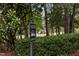 A clear sign indicating a golf cart crossing, surrounded by greenery and trees at 200 Frenchmans Bluff Dr, Cary, NC 27513