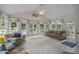 Light-filled sunroom featuring plush seating, a vaulted ceiling, and picturesque views from multiple windows at 200 Frenchmans Bluff Dr, Cary, NC 27513