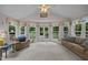 Bright sunroom with large windows, vaulted ceilings, and comfortable seating, perfect for relaxing at 200 Frenchmans Bluff Dr, Cary, NC 27513