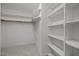 Walk-in closet features shelving, a hanging rod, and carpeted floor at 200 Frenchmans Bluff Dr, Cary, NC 27513