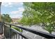 Balcony overlooks a street with mature trees and street parking at 200 S Dawson St # 114, Raleigh, NC 27601