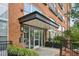 Building entrance with secure access and modern planters at 200 S Dawson St # 114, Raleigh, NC 27601