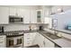 Modern kitchen with white cabinets, stainless steel appliances, and granite countertops at 200 S Dawson St # 114, Raleigh, NC 27601