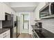 Kitchen with stainless steel appliances and easy access to laundry at 200 S Dawson St # 114, Raleigh, NC 27601