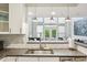 Bright kitchen with stainless steel sink, pendant lights and view to great room at 200 S Dawson St # 114, Raleigh, NC 27601
