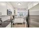 Well-lit kitchen boasts stainless steel appliances, and sleek cabinets with a view to outside at 200 S Dawson St # 114, Raleigh, NC 27601