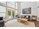 Bright living room with hardwood floors, high ceilings, and comfortable seating at 200 S Dawson St # 114, Raleigh, NC 27601