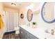 Bathroom with double sinks, modern fixtures, and a shower and tub combo, creating a stylish and functional space at 2120 Northcrest Dr, Elon, NC 27244