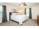Spacious bedroom featuring carpet, two windows, ceiling fan, and large bed for comfort and relaxation at 2120 Northcrest Dr, Elon, NC 27244