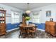 Cozy dining room with a round table, wood chairs, two windows, and decorative cabinets for a warm and inviting atmosphere at 2120 Northcrest Dr, Elon, NC 27244