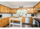Kitchen with wooden cabinets, modern appliances, and an island providing extra counter space at 2120 Northcrest Dr, Elon, NC 27244