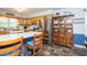 Eat-in kitchen featuring stainless steel refrigerator, wood cabinets, and breakfast bar with modern flooring and decor at 2120 Northcrest Dr, Elon, NC 27244