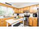 Functional kitchen with wooden cabinets, stainless steel appliances, and bright countertop at 2120 Northcrest Dr, Elon, NC 27244