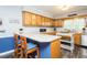 Bright eat-in kitchen featuring wood cabinets, a breakfast bar, and modern appliances for a delightful cooking experience at 2120 Northcrest Dr, Elon, NC 27244