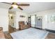 Cozy living room with hardwood floors, ceiling fan, and ample natural light from the front door at 2120 Northcrest Dr, Elon, NC 27244