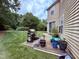 Outdoor patio area with BBQ grill and greenery, perfect for entertaining and outdoor living at 2228 Cedar Grove Dr, Durham, NC 27703