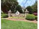 Stone entrance sign for Alexander Crossing community featuring lush landscaping and a welcoming atmosphere at 2228 Cedar Grove Dr, Durham, NC 27703