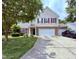 Traditional two-story home with a two-car garage, manicured lawn, and inviting curb appeal at 2228 Cedar Grove Dr, Durham, NC 27703