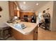 Open kitchen with wood cabinets, laminate floors, and countertops with barstool seating at 2228 Cedar Grove Dr, Durham, NC 27703