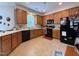 Efficient kitchen features wood cabinets, laminate floors and countertops, and black appliances at 2228 Cedar Grove Dr, Durham, NC 27703