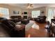 Spacious living room with hardwood floors, plush sofas, and a cozy fireplace with an electric display at 2228 Cedar Grove Dr, Durham, NC 27703