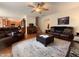 A wide view of a living room with sofas, hardwood floors, ceiling fan, and an open layout at 2228 Cedar Grove Dr, Durham, NC 27703