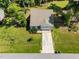 Aerial view of single Gathering home featuring mature trees, verdant lawn and long driveway at 2321 Blue Crab Ct, Wake Forest, NC 27587