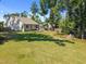 Spacious backyard featuring a lush green lawn, mature trees, and a fire pit area at 2321 Blue Crab Ct, Wake Forest, NC 27587