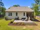 Back of house featuring a spacious deck with patio furniture and manicured landscaping at 2321 Blue Crab Ct, Wake Forest, NC 27587