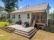 Back of house featuring a spacious deck with patio furniture and a screened in porch at 2321 Blue Crab Ct, Wake Forest, NC 27587