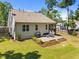 Back of house featuring a spacious deck with patio furniture and manicured landscaping at 2321 Blue Crab Ct, Wake Forest, NC 27587