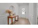 Inviting foyer featuring wainscoting, neutral paint, a wood console table and luxury vinyl floors at 2321 Blue Crab Ct, Wake Forest, NC 27587