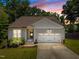 Charming single Gathering home featuring a manicured lawn and attached two car garage at 2321 Blue Crab Ct, Wake Forest, NC 27587