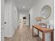 Inviting hallway featuring wood floors, crisp white trim, and a view into the spacious living room at 2321 Blue Crab Ct, Wake Forest, NC 27587