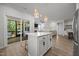 Open kitchen featuring a central island, stainless steel appliances, and seamless flow into the adjacent living and dining areas at 2321 Blue Crab Ct, Wake Forest, NC 27587
