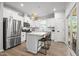 Bright, white kitchen with stainless steel appliances, island with seating, and access to the outdoors at 2321 Blue Crab Ct, Wake Forest, NC 27587