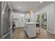 Modern kitchen featuring stainless steel appliances, white cabinetry, and island seating, with outdoor access at 2321 Blue Crab Ct, Wake Forest, NC 27587
