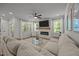 Spacious living room features a fireplace, ceiling fan and large windows for ample natural light at 2321 Blue Crab Ct, Wake Forest, NC 27587