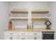 Stylish wine and serving area with wine storage, floating shelves, and decorative backsplash at 2321 Blue Crab Ct, Wake Forest, NC 27587