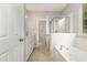 Bathroom featuring a large bathtub, shower, and a vanity with double sinks, exuding comfort at 2409 Valley Haven Dr, Raleigh, NC 27603