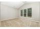 Bedroom with three large windows allowing for ample natural light and neutral walls and carpet at 2409 Valley Haven Dr, Raleigh, NC 27603