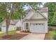 Two-story home with bay window, an attached garage, and landscaping around a tree-shaded yard at 2409 Valley Haven Dr, Raleigh, NC 27603