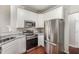 This kitchen features stainless steel appliances, granite countertops, and white cabinets at 2409 Valley Haven Dr, Raleigh, NC 27603