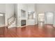 Spacious living room features a fireplace, beautiful wood-look floors, and stairs to the second floor at 2409 Valley Haven Dr, Raleigh, NC 27603